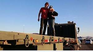 Welcome Home Troops photo couple posing on flatbed military transport